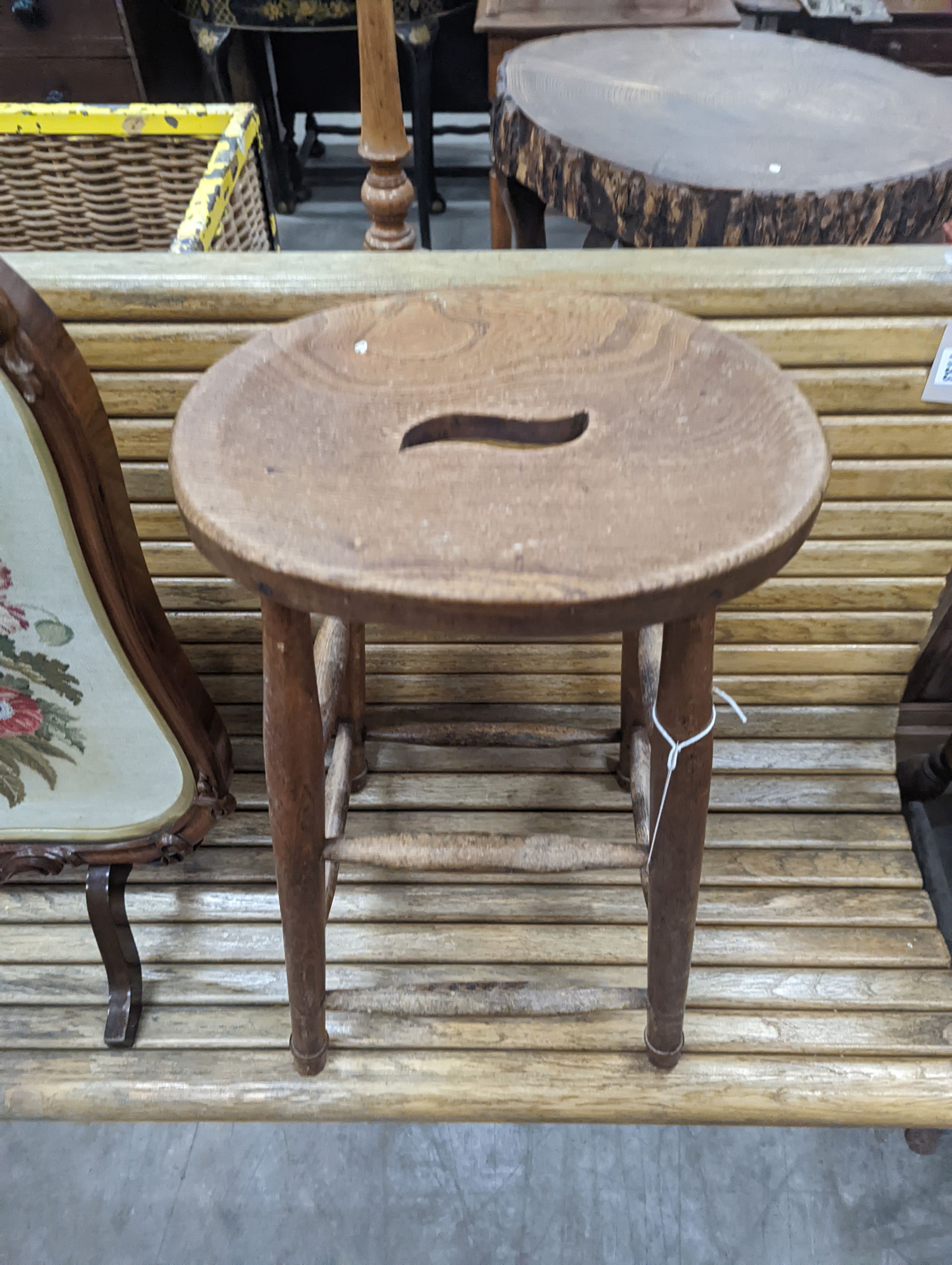 An elm and beech stool together with a Victorian rosewood tapestry firescreen